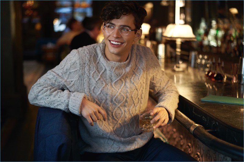 All smiles, Ryan Winter wears a cable-knit sweater for Original Penguin's fall-winter 2017 campaign.