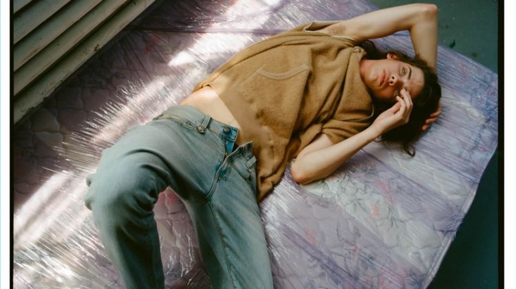 Relaxing, Erin Mommsen wears a cutoff cotton-blend sweatshirt $595 and boy slim jeans $365 by R13.