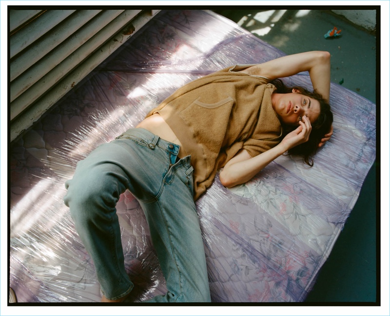 Relaxing, Erin Mommsen wears a cutoff cotton-blend sweatshirt $595 and boy slim jeans $365 by R13.