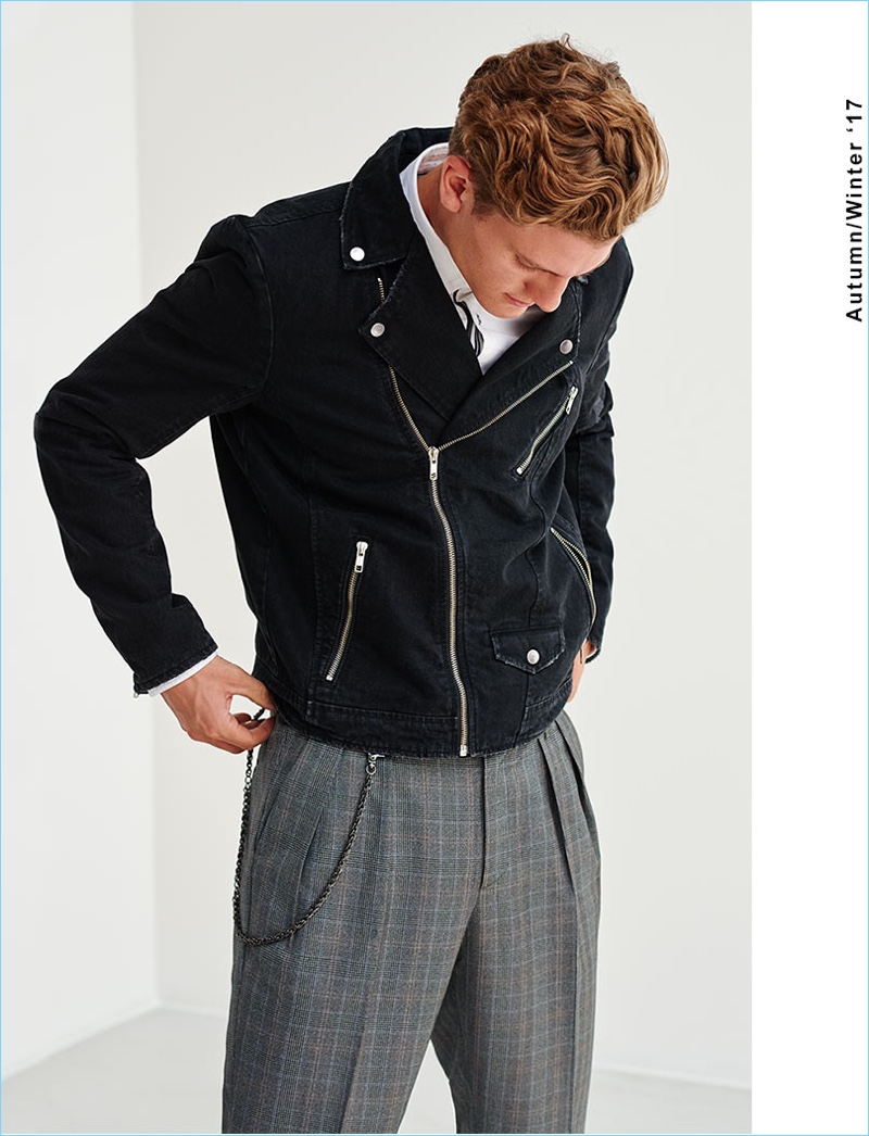 Model Mikkel Jensen sports pleated check trousers with a biker jacket from Reserved.