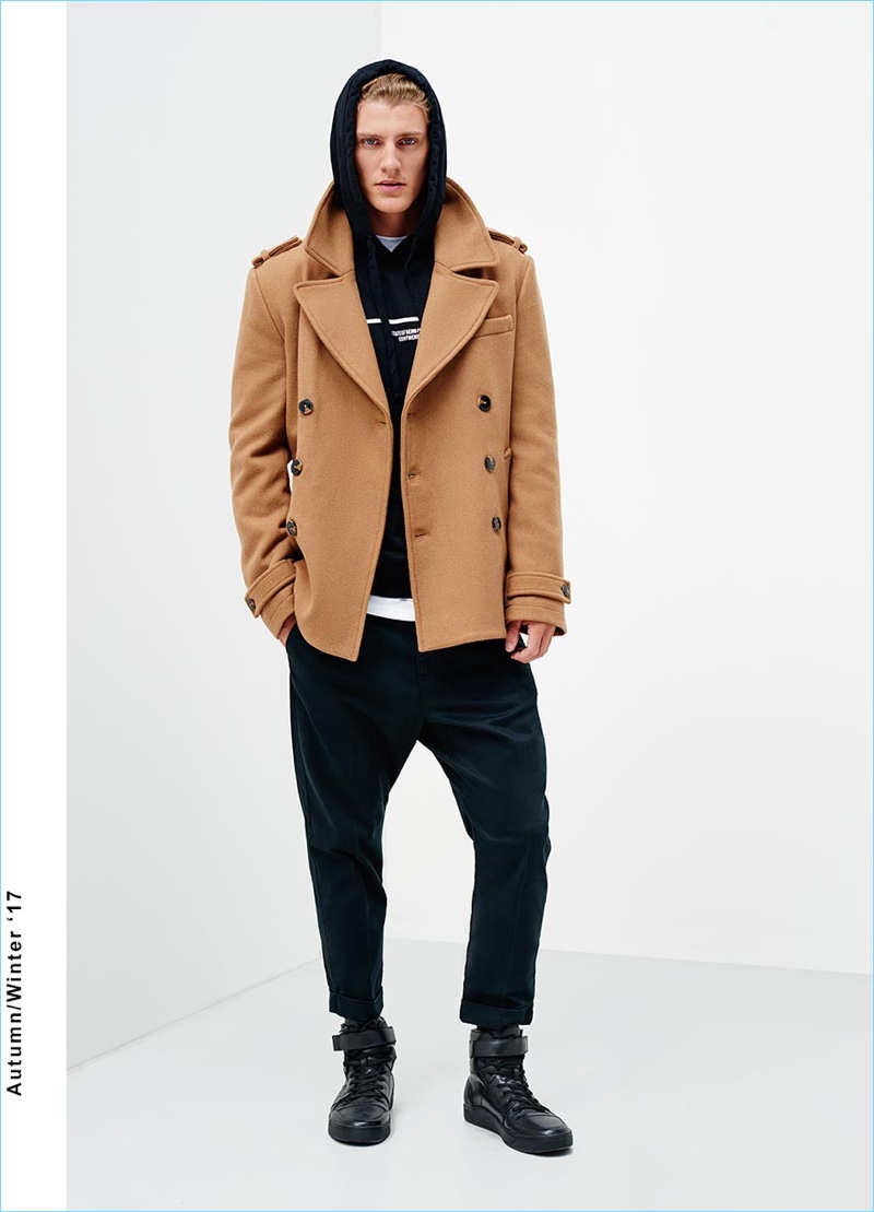 A trendy vision, Mikkel Jensen sports drop crotch pants with a short double-breasted jacket and hoodie.