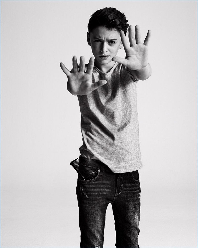 Noah Schnapp wears a Dolce & Gabbana t-shirt with Levi's jeans.