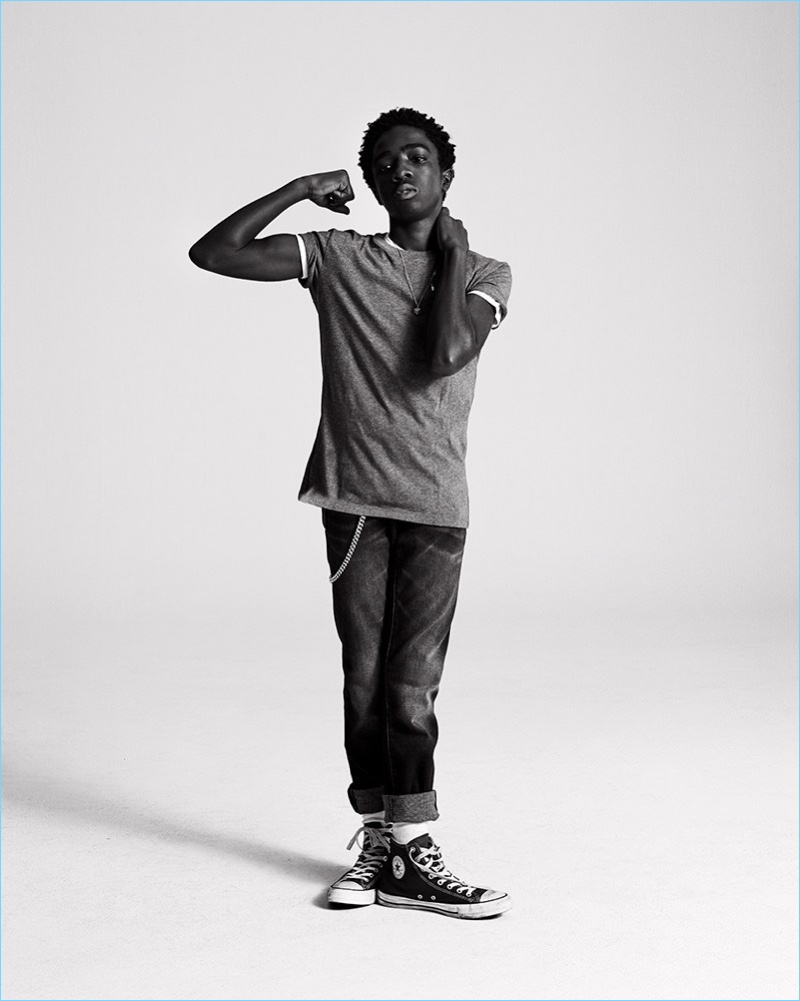 Caleb McLaughlin rocks a grey UNIQLO t-shirt, white Dolce & Gabbana tee, Armani exchange jeans, and an A.P.C. necklace.