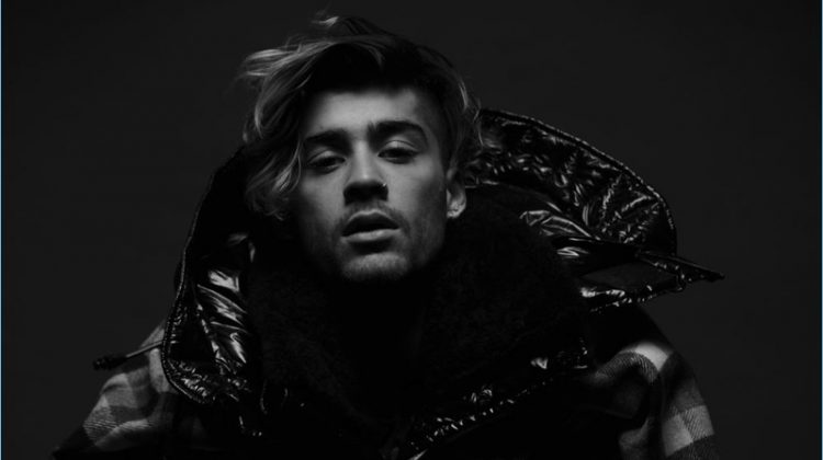 Layered for fall, Zayn Malik wears a Woolrich shirt with a Dsquared2 coat, Prada jacket, and Calvin Klein shirt.