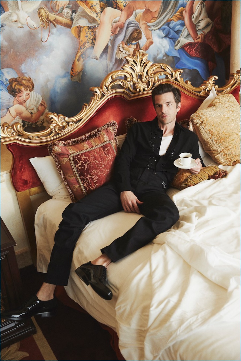 Relaxing in bed, Brandon Flowers wears a black look by Saint Laurent with a Hanes tank.