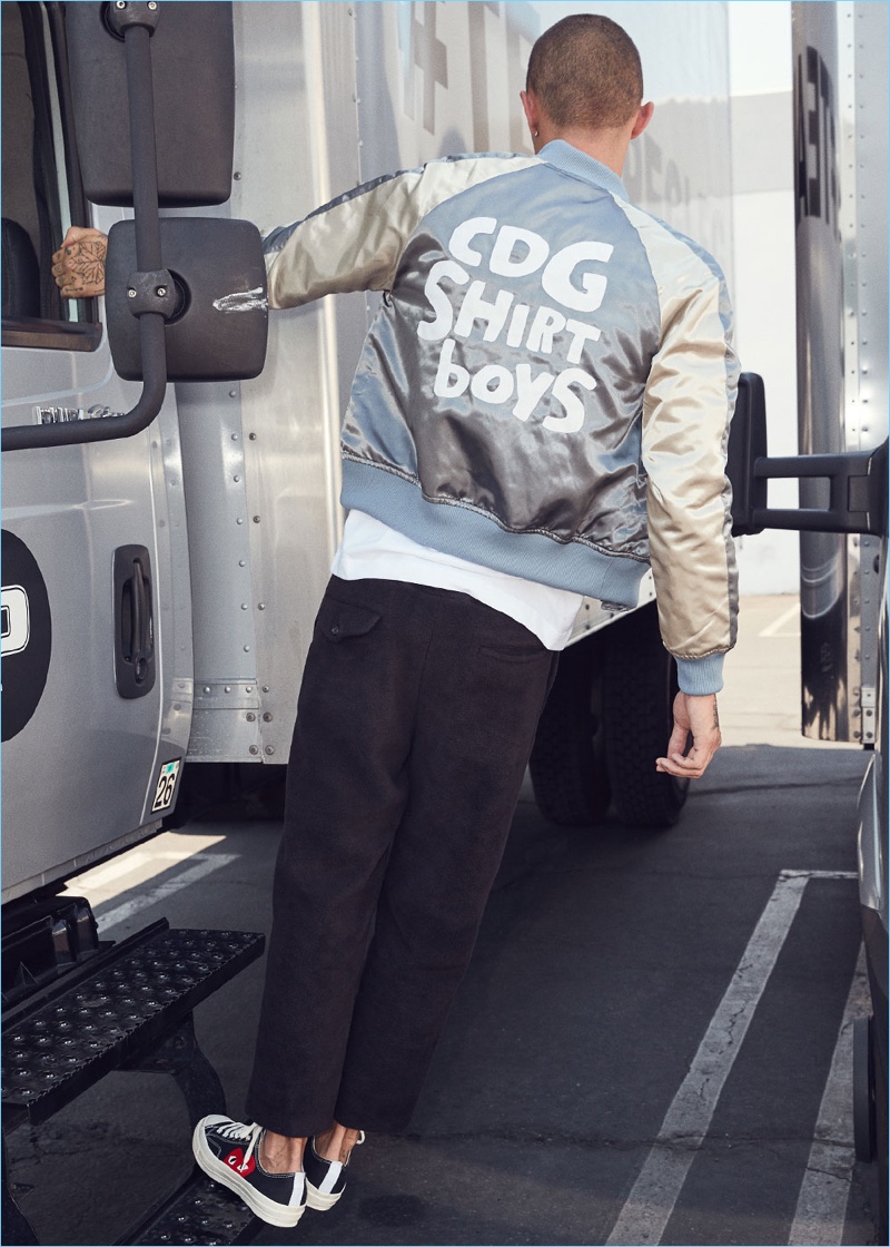Model Simon Kotyk represents for Comme des Garçons Shirt in a quilted bomber jacket $571. He also wears Comme des Garçons Homme Plus fleece pants $345 and Comme des Garcons Play Converse sneakers $125.