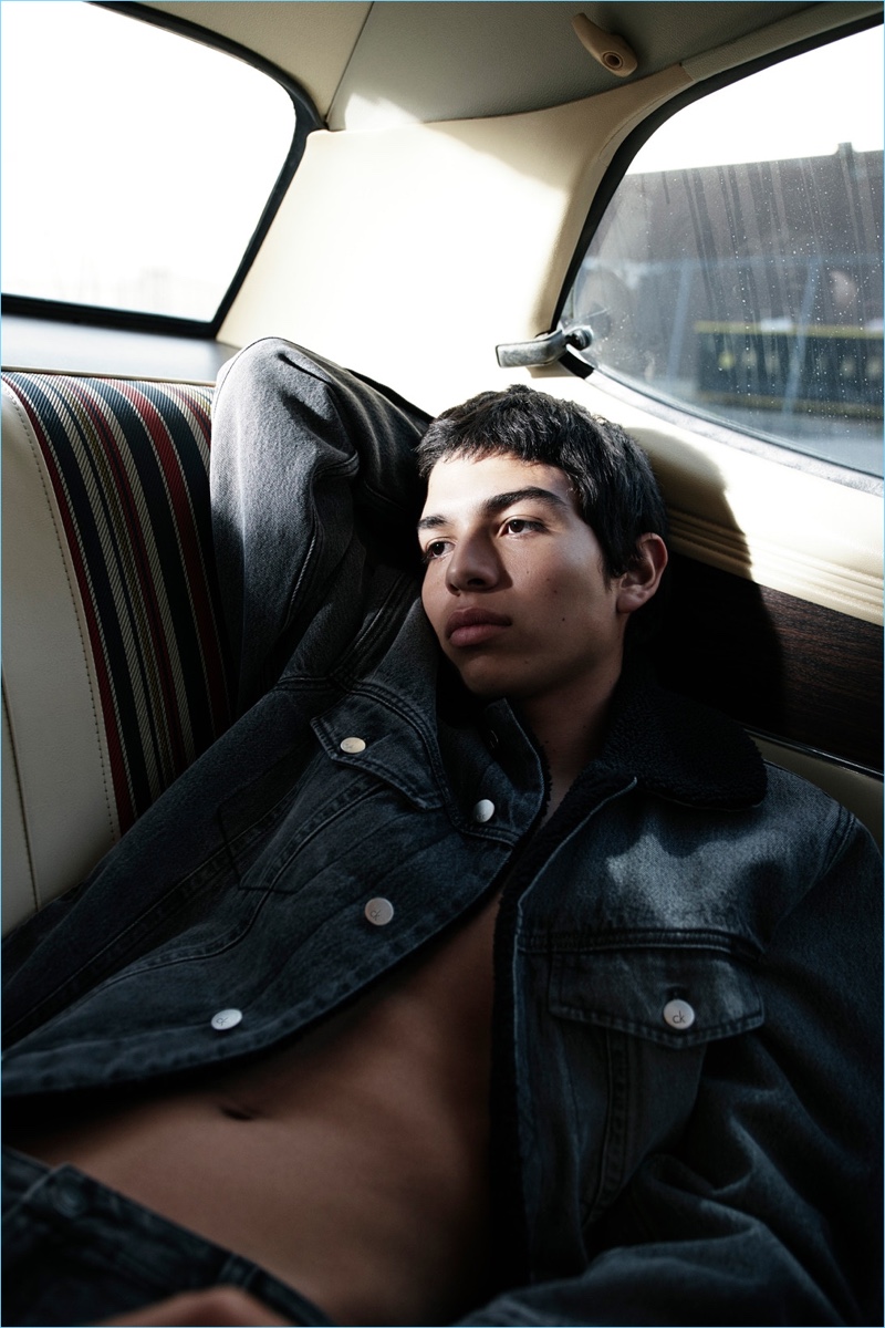 Ernesto Cervantes lounges in the back of a car for Calvin Klein Jeans' fall-winter 2017 campaign.