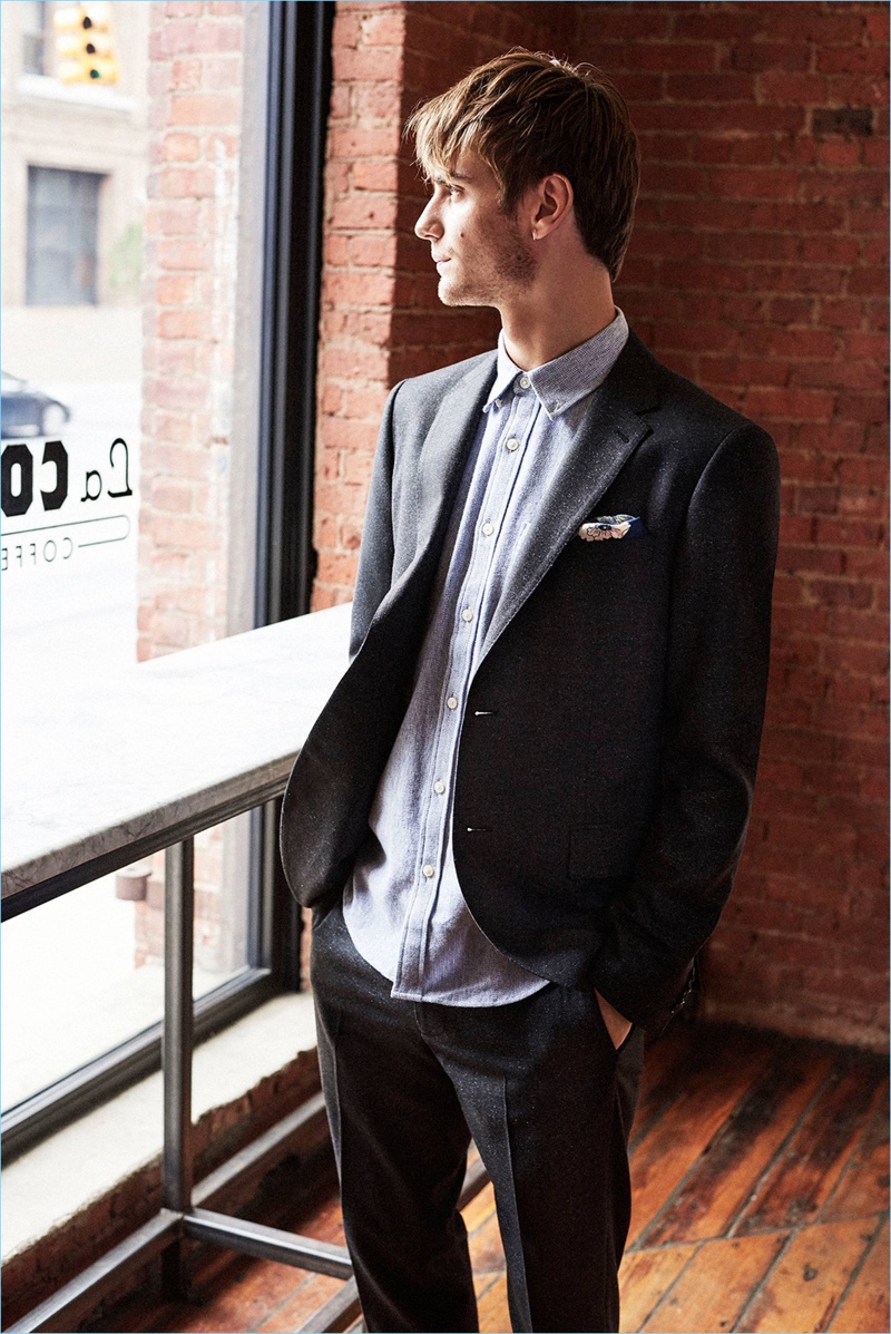 Wearing a sleek ensemble from Club Monaco, Ben Allen sports a suit with a flannel twill shirt.