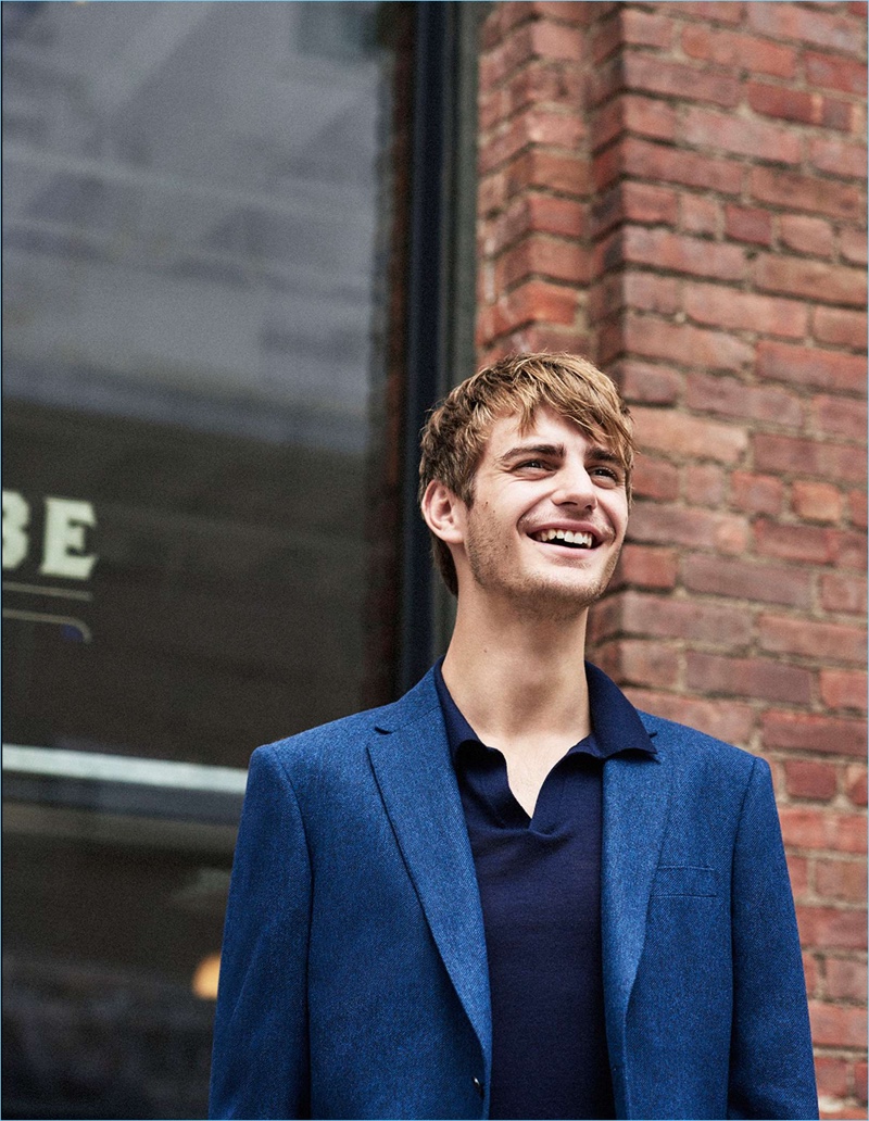 All smiles, Ben Allen wears a Club Monaco blazer with a merino polo.