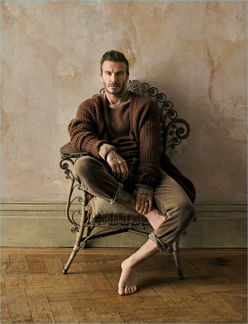 David Beckham sports a brown cardigan, sweater, and pants by Stella McCartney.