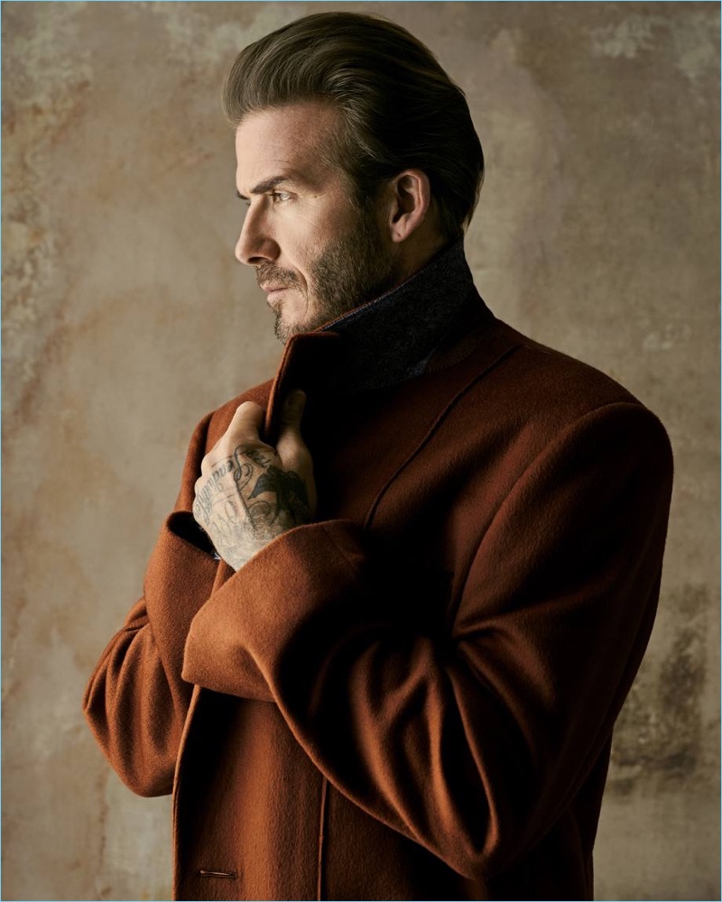 Delivering a side profile, David Beckham dons an Ermenegildo Zegna Couture coat.