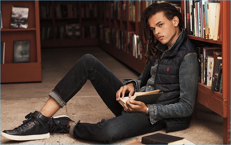 Don Lee layers with a POLO Ralph Lauren vest and denim jacket. The model's look is complete with skinny jeans and leather high-top sneakers.