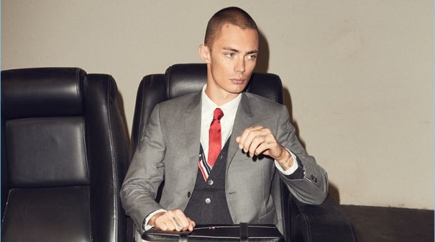 Business Refresh: Forward Updates Tailored Style Forward makes a stylish case for Thom Browne. Model Simon Kotyk wears a classic wool suit from the brand. He also sports a Thom Browne shirt, cardigan, tie, and leather boots.
