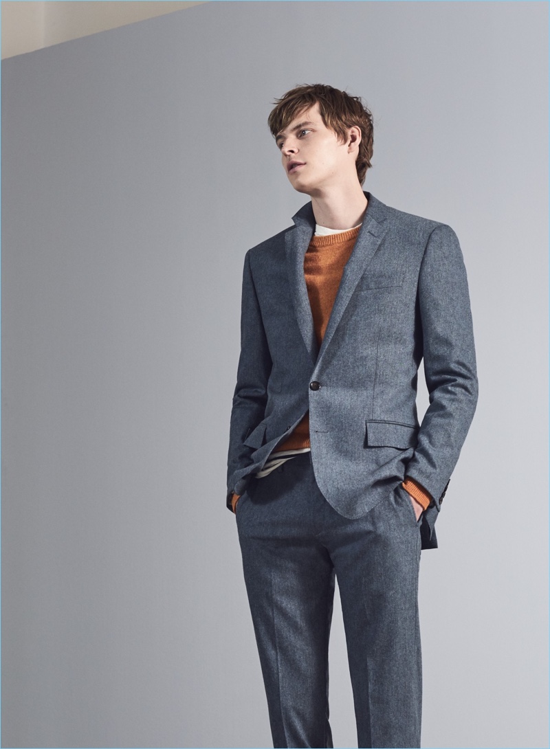 A Suit That Multitasks: John Hein dons a Ludlow slim suit jacket $425 and pants $225. He also wears a J.Crew lambswool sweater $69.50 and striped t-shirt $45.