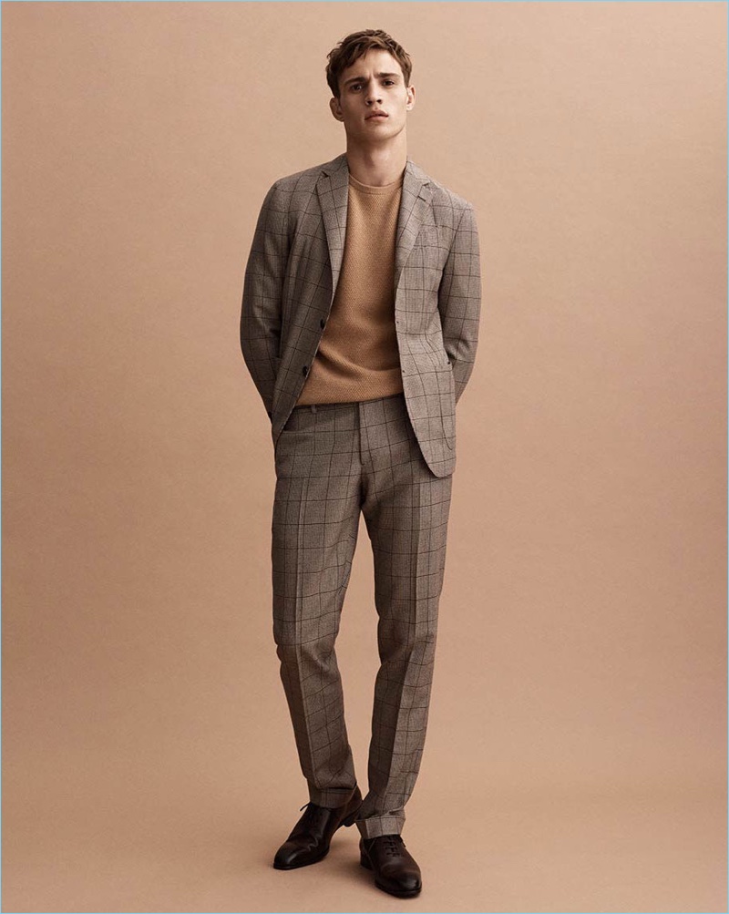 Channeling 60s style, Julian Schneyder dons a check suit by Massimo Dutti.