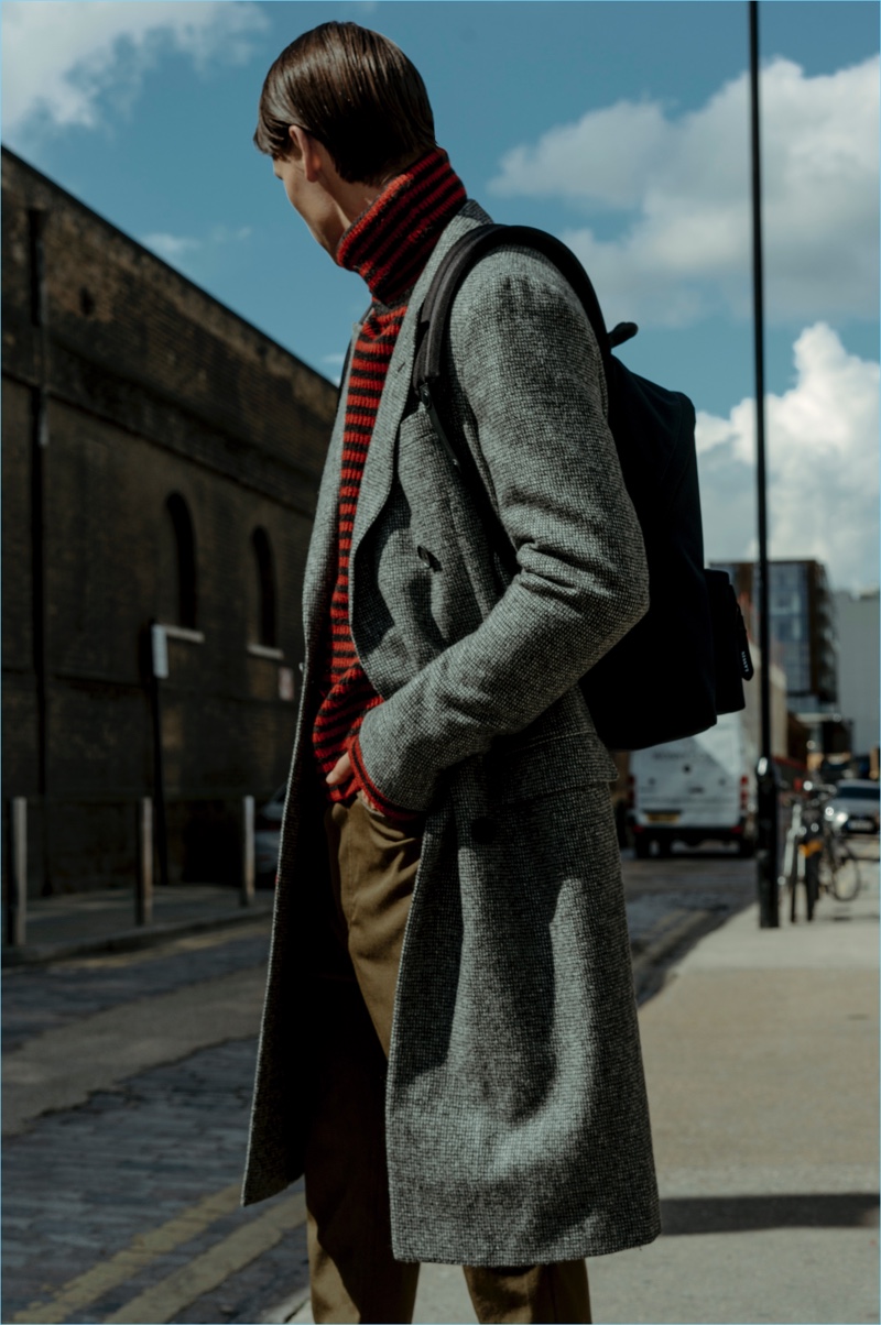 Lanvin's creative director Lucas Ossendrijver regularly revisits menswear essentials with a contemporary spin. Here, model Paul F. wears a Lanvin double-breasted wool coat $1,830. He also sports a Lanvin striped turtleneck $725, wool trousers $580, and a backpack $830.