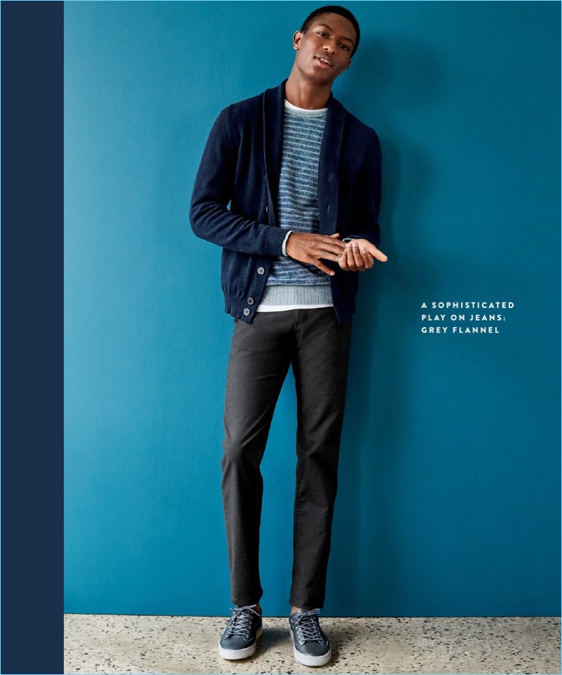 Hamid Onifade trades out his denim jeans for Brax "Woolook" trousers $198. Completing a smart look, Hamid also wears a John Smedley cardigan $470, Faherty sweatshirt $168 and TCG sneakers $160.