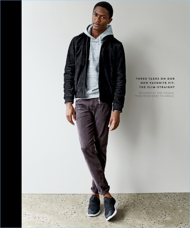 Tackling a slim-straight fit, Hamid Onifade wears Paige jeans $199 with a Ted Baker London suede jacket $819. The model also sports a Reigning Champ french terry hoodie $145 and Nike sneakers $110.