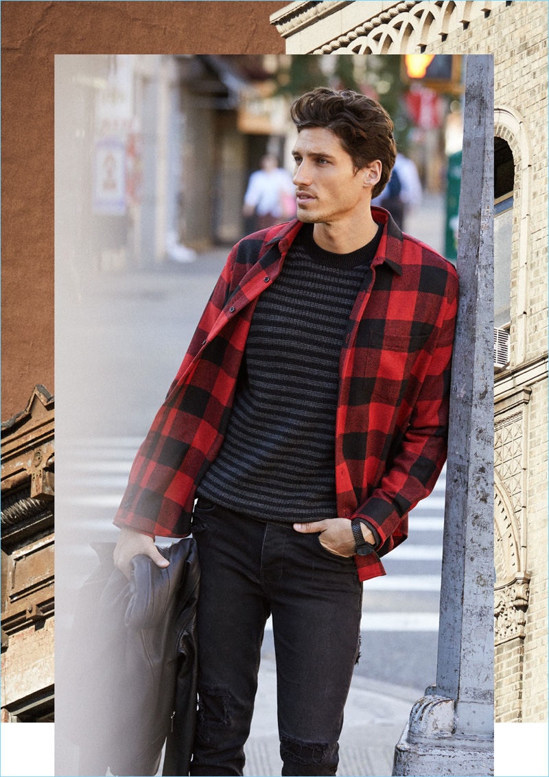 Check, Please: Take hold of a rugged essential with AMI's red and black buffalo check shirt $259. Here, Ryan Kennedy wears the must-have with Ksubi jeans $240, a McQ Alexander McQueen sweater $370 and Nixon watch $100.
