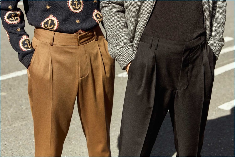 Mr Porter makes a case for pleated trousers with a brown pair from Kent & Curwen, alongside a black alternative by Prada. The models also sports a Gucci anchor print sweater, Officine Generale turtleneck, and Lanvin blouson jacket.