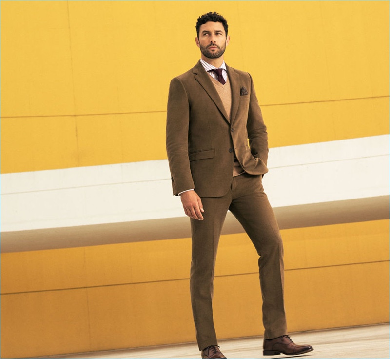 Posing against a yellow backdrop, Noah Mills stars in Pedro del Hierro's fall-winter 2017 campaign.