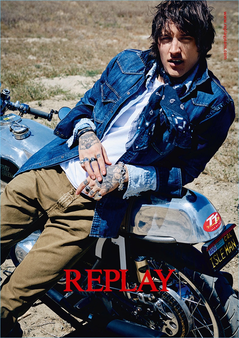 Leebo Freeman rocks a distressed denim shirt and khaki pants for Replay's fall-winter 2017 campaign.