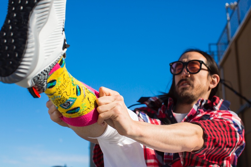 DJ Steve Aoki adjusts a pair of socks from his Happy Socks collaboration.