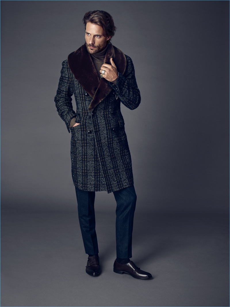Tommy Dunn sports a fur accented double-breasted coat for Tagliatore's fall-winter 2017 campaign.