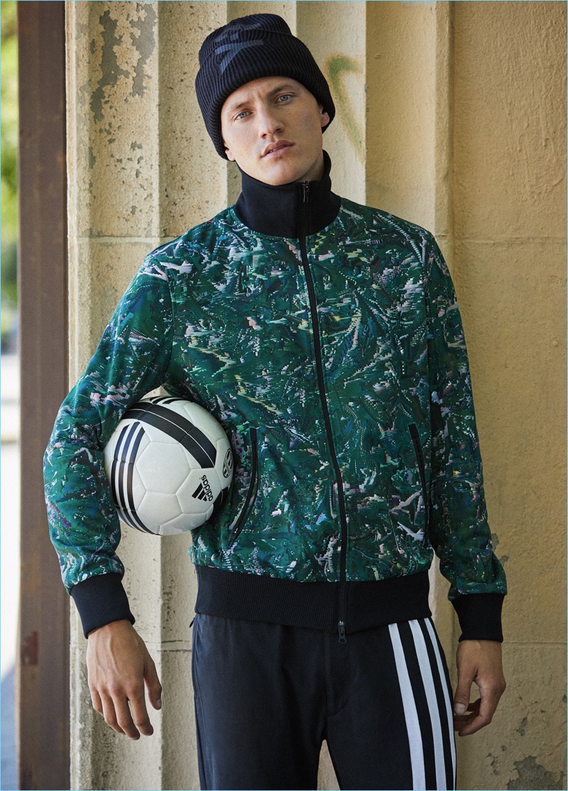 Eli Hall rocks a Y-3 classic AOP track jacket $320, long-sleeve tee $160, logo beanie $130, and stripes long johns $200.