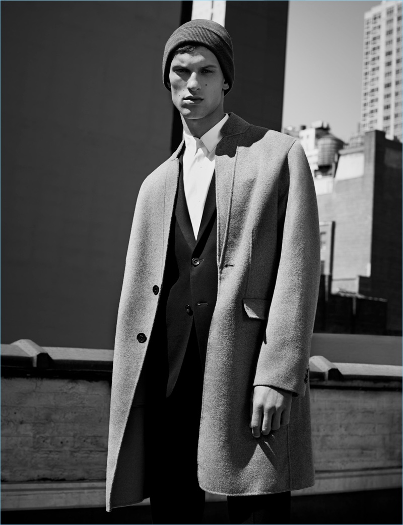 Connecting with Zara Man, David Trulik wears a sharp overcoat with a modern silhouette.