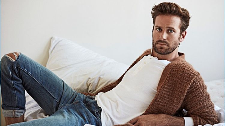 Connecting with OUT, Armie Hammer wears a Stella McCartney cardigan, John Varvatos henley, and Frame Denim jeans.