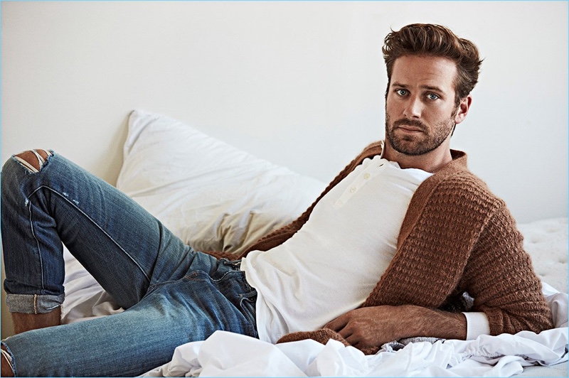 Connecting with OUT, Armie Hammer wears a Stella McCartney cardigan, John Varvatos henley, and Frame Denim jeans.