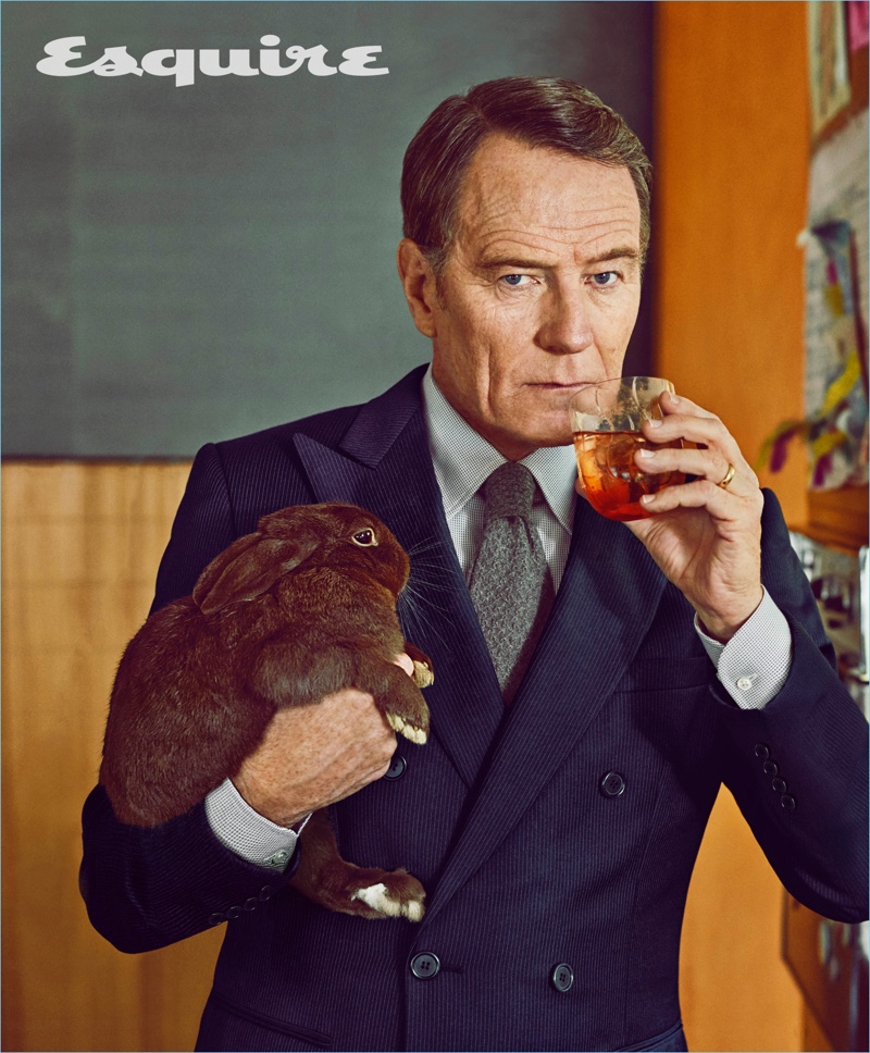 Holding a rabbit, Bryan Cranston wears an Emporio Armani suit with a Giorgio Armani shirt and Paul Stuart tie.