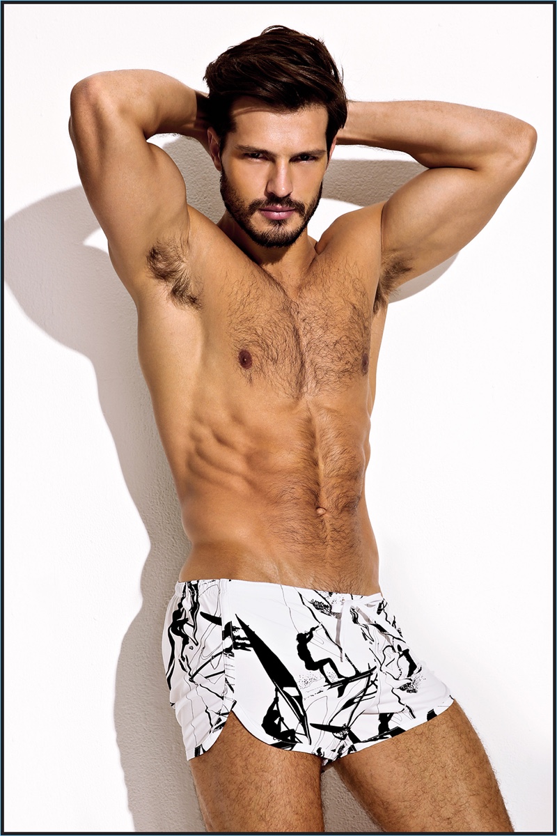 Flexing, Diego Miguel models swim shorts from Charlie by Matthew Zink.