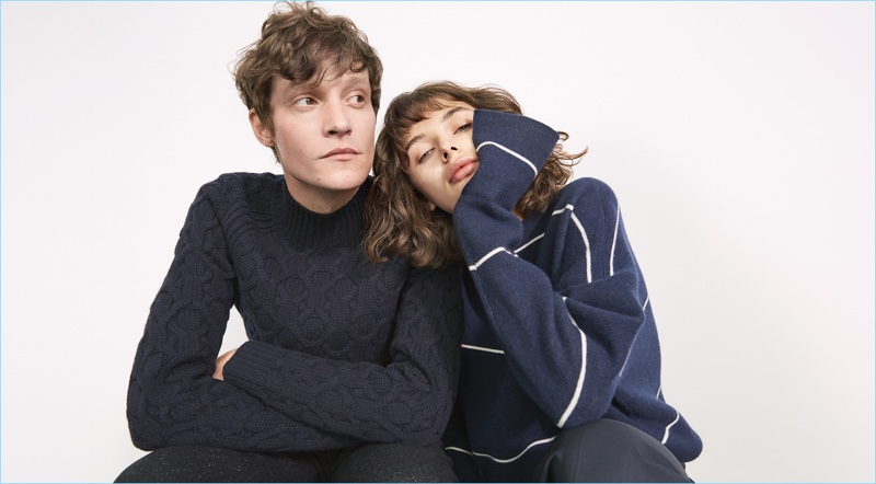 Models Matthew Hitt and Renata Gubaeva embrace for Club Monaco's winter 2017 campaign. Embracing a classic, Matthew wears one of the brand's chunky cable-knit sweaters.