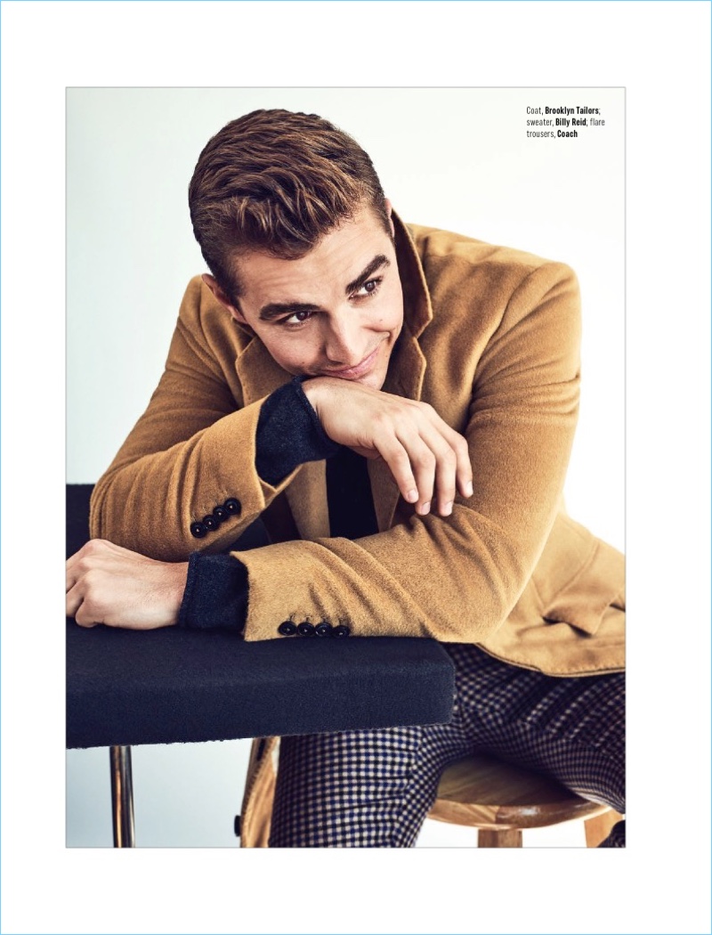 All smiles, Dave Franco wears a Brooklyn Tailors coat, Billy Reid sweater, and Coach trousers.