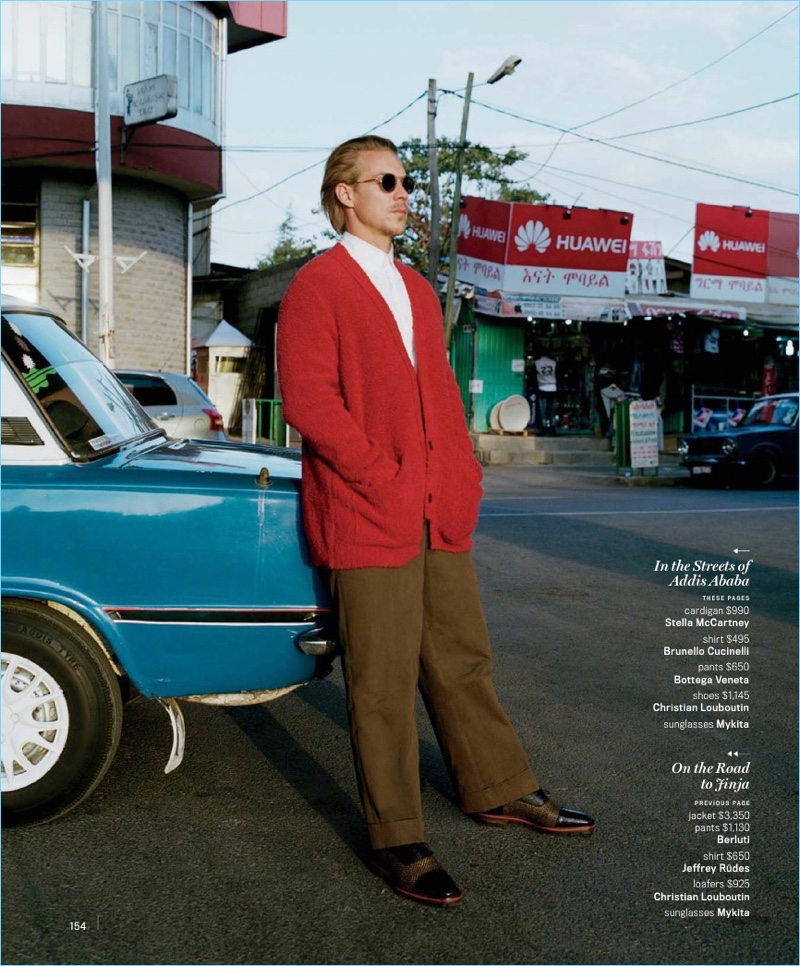 Taking to the streets of Addis Ababa, Diplo wears a red cardigan by Stella McCartney. He also wears a Brunello Cucinelli shirt, Bottega Veneta trousers, Mykita sunglasses, and Christian Louboutin shoes.