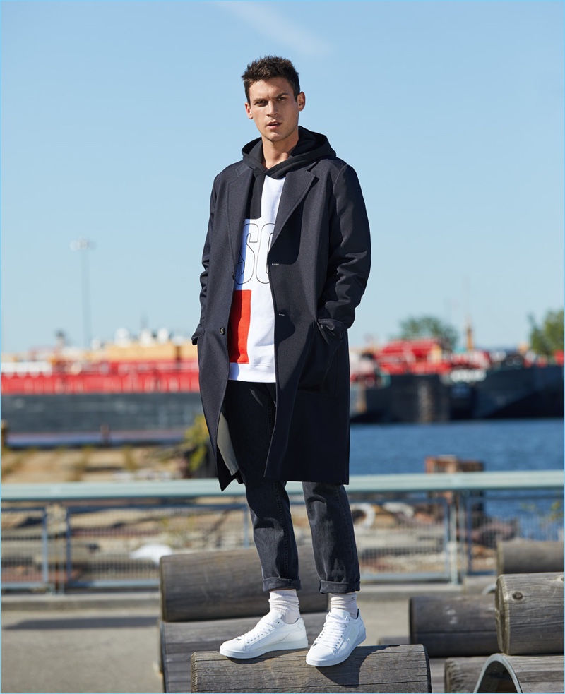 Graphic Jam: Stepping out, Miles Garber wears a MSGM x Diadora sweatshirt with a Marni topcoat. The American model also sports Billy Reid jeans, Rick Owens DRKSHDW socks, and Kenzo sneakers.