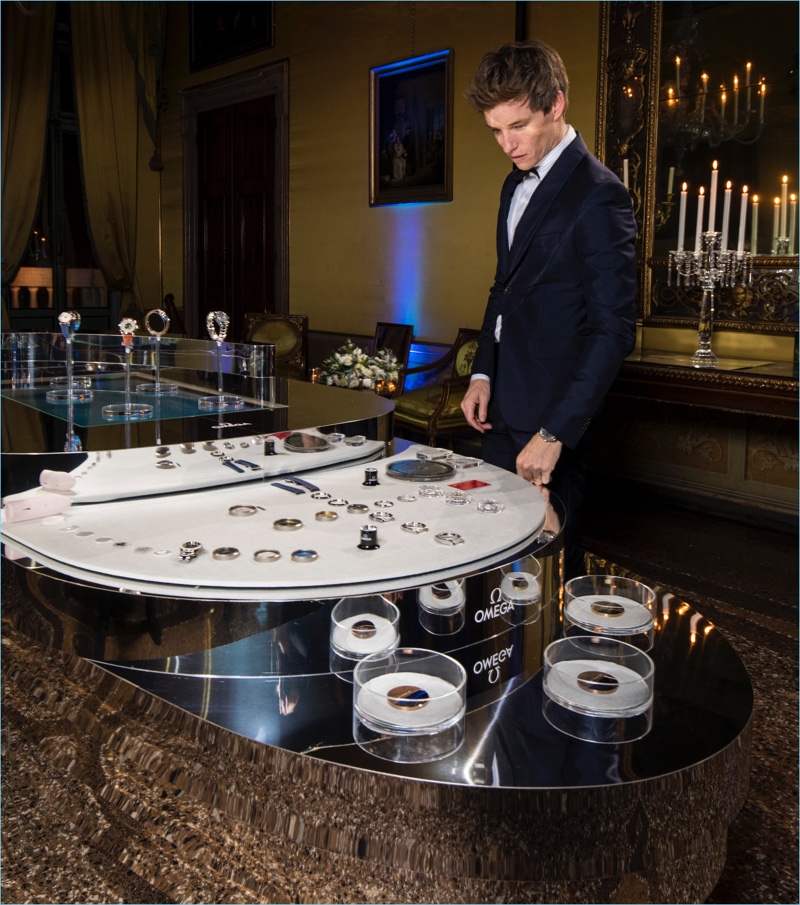 Actor Eddie Redmayne looks at OMEGA's Aqua Terra collection.