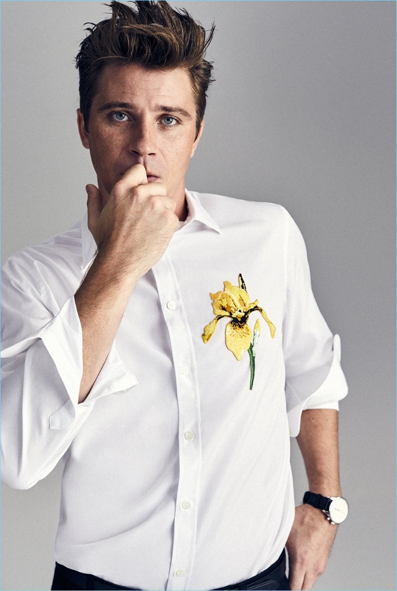 Front and center, Garrett Hedlund wears an Alexander McQueen shirt, Prada trousers, and a Zenith watch.