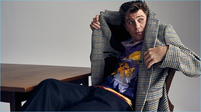 Posing for a cheeky image, Garrett Hedlund wears a Raf Simons houndstooth blazer with a Prada shirt and trousers.