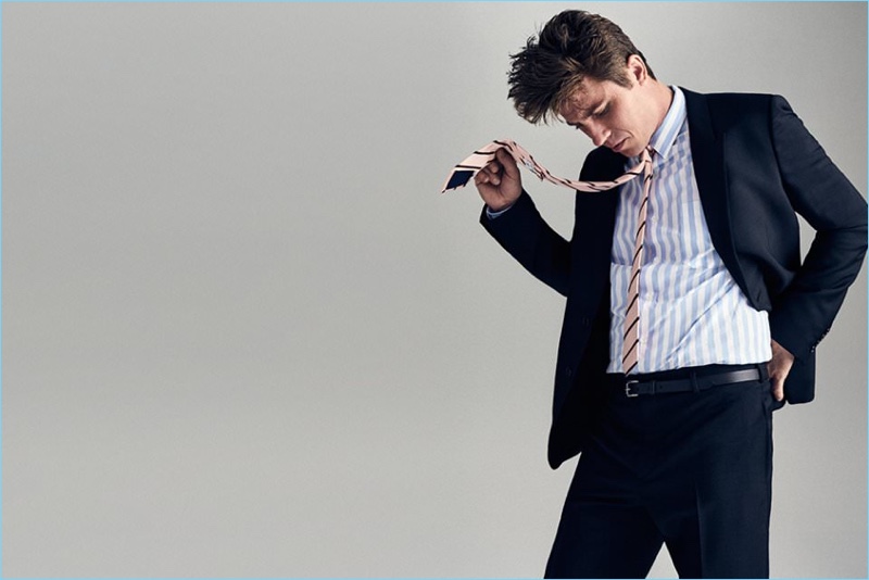 A smart vision, Garrett Hedlund wears a Saint Laurent suit with a striped AMI shirt, Kingsman + Drake's tie, and Prada belt.
