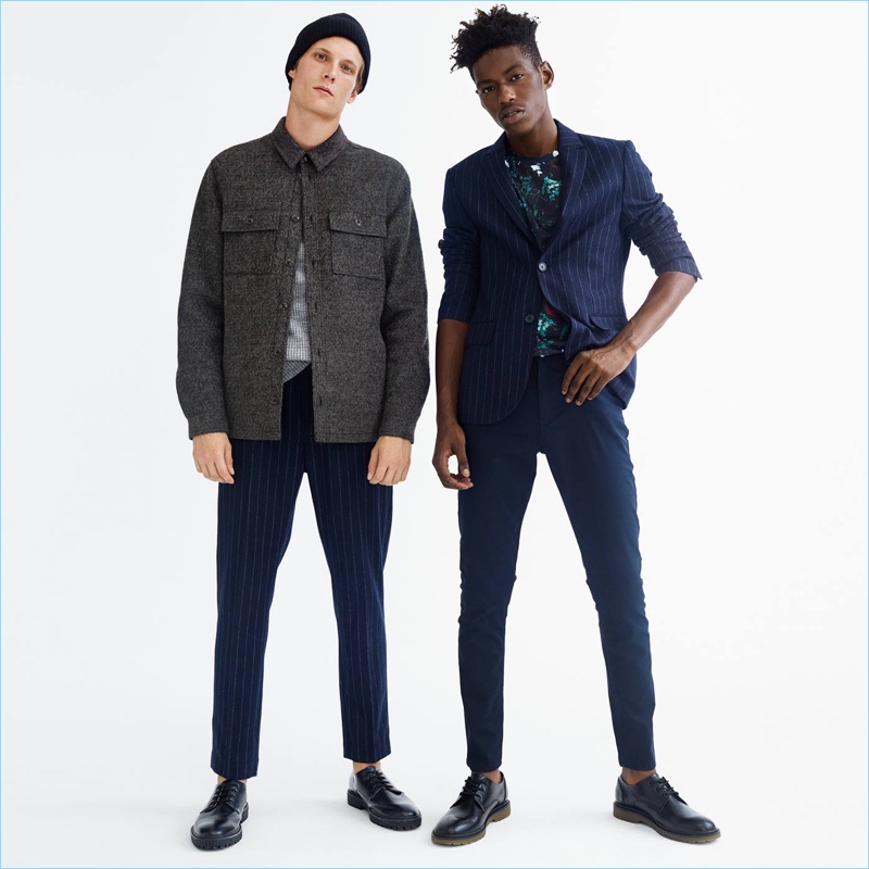 Left: Channeling workwear vibes, Felix Gesnouin wears a H&M wool-blend shirt jacket. The French model also sports a thermal sweater and pinstripe suit pants. A knit beanie and chunky-soled derby shoes complete his look. Right: Sheani Gist models a H&M pinstripe suit jacket with an all-over print t-shirt. Smart suit pants and dress shoes also make a sound impression.