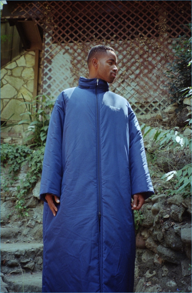 Making a dramatic statement, Jay Ellis wears a blue Balenciaga raincoat.