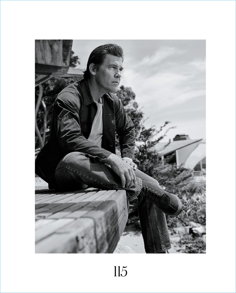 Sitting for a picture, Josh Brolin wears a Blue Blue Japan shirt with a Current/Elliott t-shirt. He also sports Dries Van Noten jeans and Grenson boots.