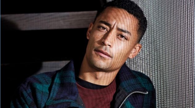 Connecting with Men's Health UK, Loyle Carner wears a check Oliver Spencer jacket with an A.P.C. sweatshirt. Carner also dons a Paul Smith t-shirt and Carhartt WIP trousers.
