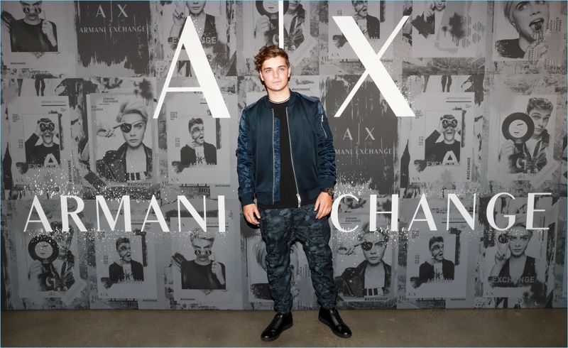 Martin Garrix rocks a sporty look from Armani Exchange. He wears a bomber jacket with camouflage joggers and black sneakers. » Martin Garrix Rocks Armani Exchange for New York Event Martin Garrix rocks a sporty look from Armani Exchange. He wears a bomber jacket with camouflage joggers and black sneakers.