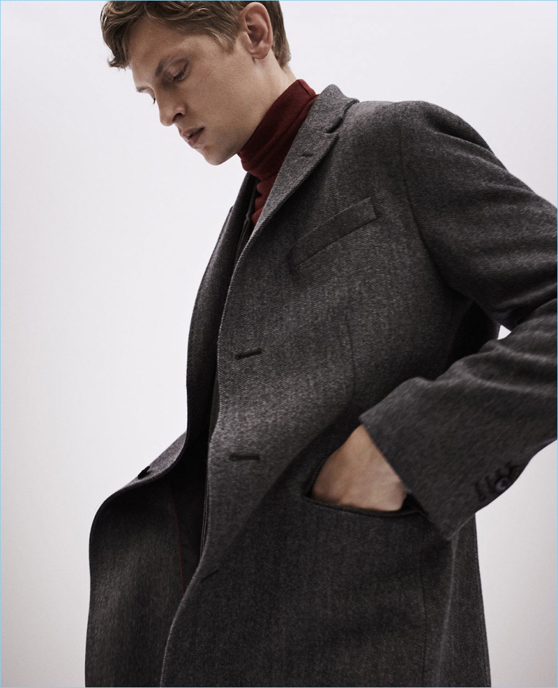 An elegant vision, Mathias Lauridsen wears a Massimo Dutti wool herringbone coat with a turtleneck sweater.