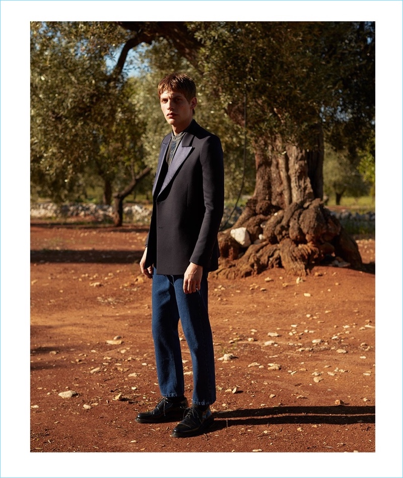 Connecting with Matches Fashion, Baptiste Radufe wears a Lanvin tuxedo jacket with a Helbers shirt and Raf Simons jeans. Baptiste's look also includes AMI shoes.