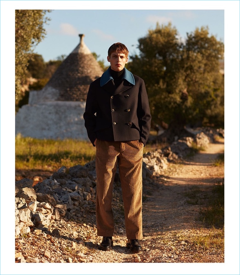 Embracing boxy proportions, Baptiste Radufe wears a Valentino peacoat with a turtleneck sweater by Lanvin. Tapping into the current trends, Baptiste also dons trousers by The Gigi.